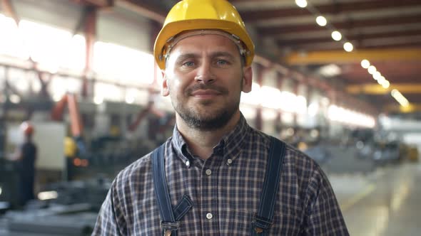 Caucasian Factory Technician Smiling with Satisfaction