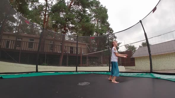 Girl On A Trampoline Outdoors