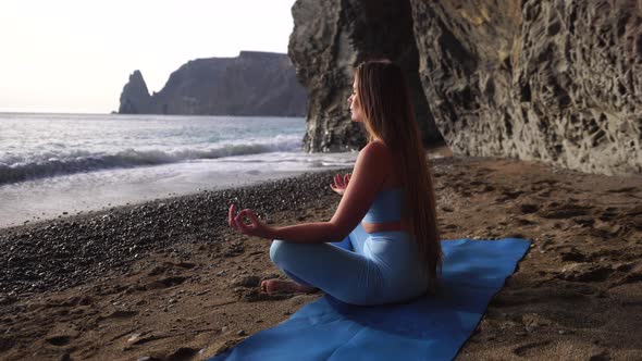 Well Looking Middle Aged Sporty Woman Fitness Instructor in Blue Sportswear Doing Stretching and