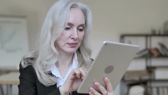 Middle Aged Businesswoman Using Tablet