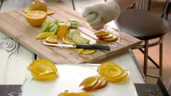 Chef Hand Processing Apple Slices with Lemon Juice