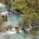 Tourist Enjoying the View of Lower Lakes in Plitvice Lakes National Park Croatia - VideoHive Item for Sale