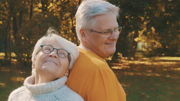 Love and Affection at Old Age. Retired Couple Enjoying Autumn Day in Forest