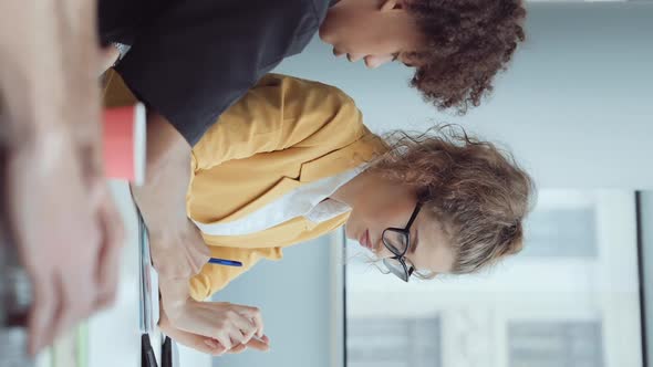 Vertical Screen Business Colleagues Discussing New Project in Office