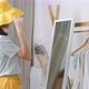 Lovely Asian girl trying the new hat in front of the mirror. - VideoHive Item for Sale