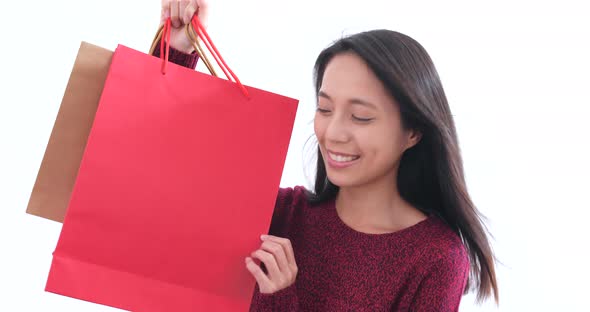 Excited woman holding shopping bag 