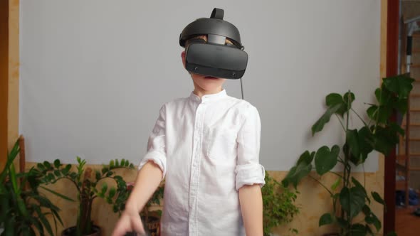 Young Boy Gaming with a VR Virtual Reality Headset at Home