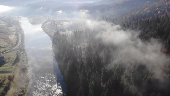 Autumn landscape in Carpathian Mountains. River, hills and coniferous forests on the slopes. Fall