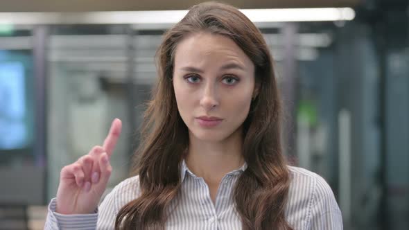 Portrait of Young Businesswoman showing No Sign by Finger