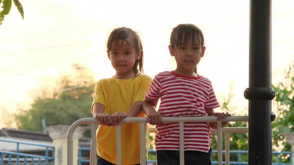 Excited little girls have fun together in the playground.