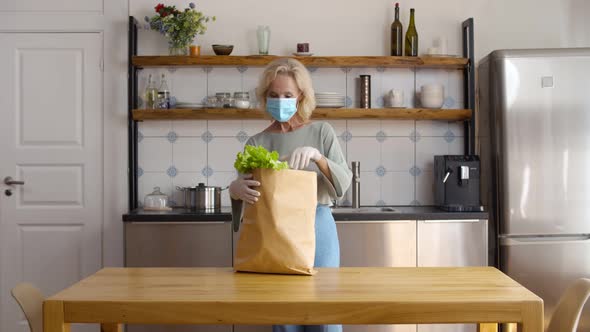 Senior Lady Receiving Home Grocery Delivery and Unpacking Food