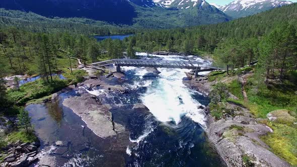 Scenic aerial view of bridge above waterfall