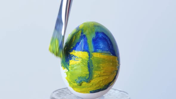 Closeup of a Person Painting Easter Eggs with a Special Brush