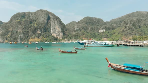 Idyllic Emerald sea water Tonsai Bay with group of docked long-tail boats Ko Phi Phi Island Thailand