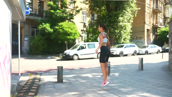 Fit Plus Size Young Woman Jumping with Skipping Rope Outdoors