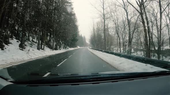 It is Snowing in Winter Road View From Car