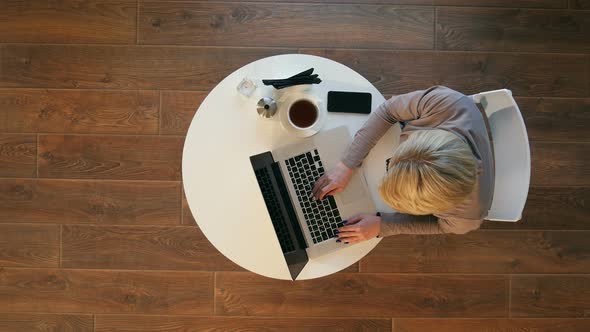 Young Woman Using Laptop While Sitting at Cafe