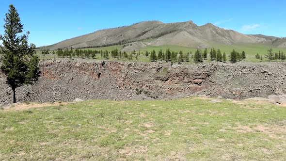 Broken Crumbled Rocks Spilling From the Narrow Canyon Slope Ridge Towards the Deep Valley Floor