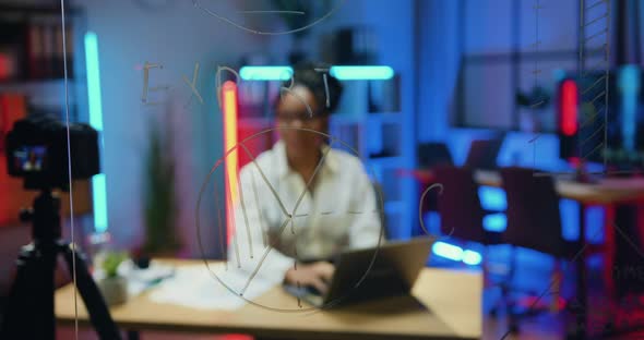 Woman which Sitting at her Workplace in Evening Office and Recording Video on Camera