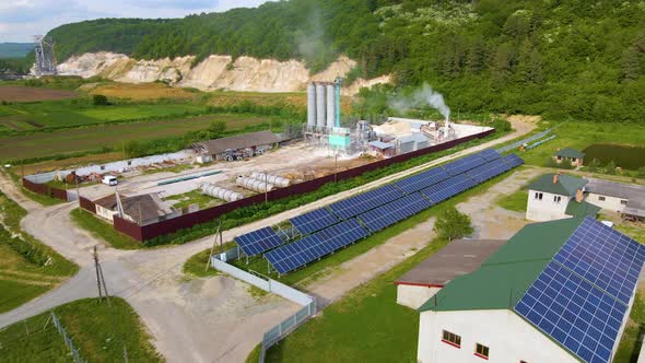 Aerial view of electrical power plant with rows of solar photovoltaic panels for producing clean