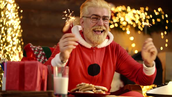 Funny Crazy Santa Claus with Sparkles, Bengal Light. New Year Holiday. Positive Human Facial