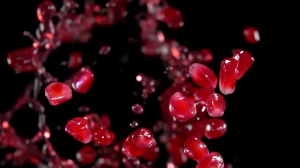 Shiny Pomegranate Grains Are Bouncing with Splashes of Red Juice