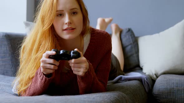 Woman playing video games in living room 4k