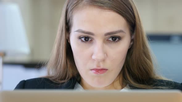 Angry Woman Working on Laptop in Office