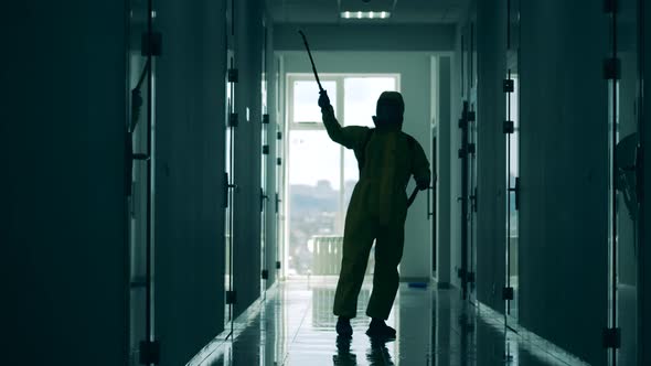 Sanitation Worker Disinfects Corridor.