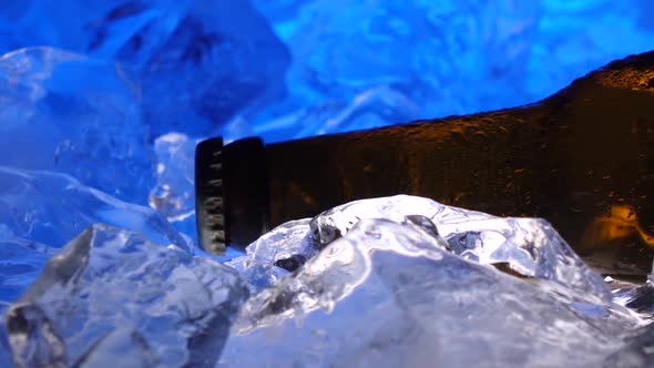 Bottle of Beer in the Ice, Like Crystals, Drops of Condensate Fall Down the Glass