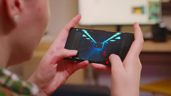 Back View of Woman Playing Shooter Games