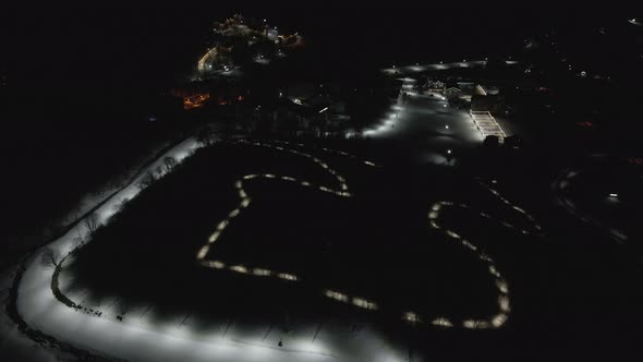 Flying at night over rope-way with gondolas at mountain resort Crystal Park in Bakuriani. 