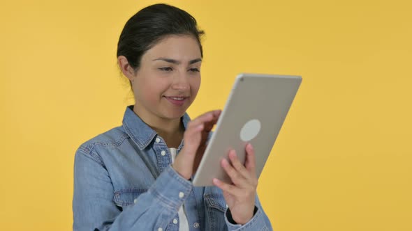 Indian Woman Using Digital Tablet, Yellow Background 