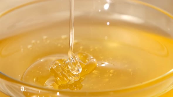 Using Spoon for Honey in Bowl, Pick It Up, Close Up