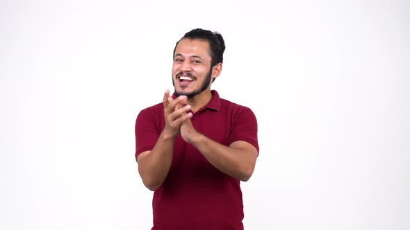 Happy young Indian man clapping with a smiling face