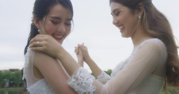 Happy Asian Lesbian Married Couple Dancing In The Park.