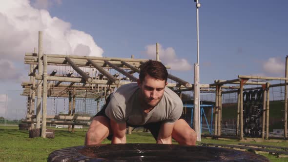 Young man training at an outdoor gym bootcamp