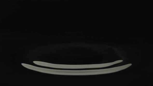 Water drop against black background. Slow Motion. Unedited version is included at the end of clip. alt