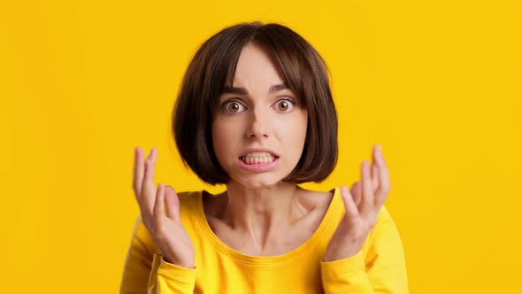Shocked Young Woman Touching Head Worrying And Panicking Yellow Background
