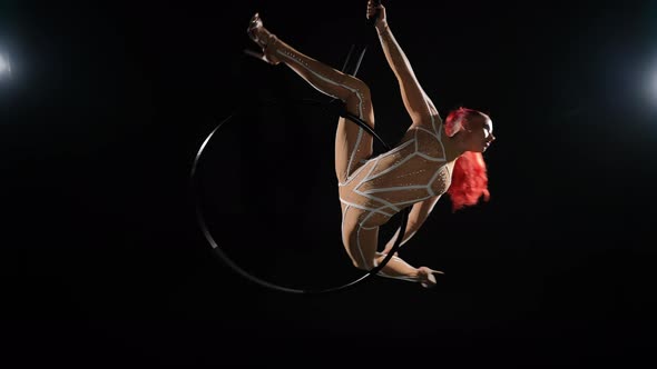 Wide Shot Gorgeous Redhead Flexible Woman in Side Split Spinning on Air Hoop in Slow Motion Smiling