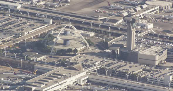 Aerial helicopter shot, overhead shot of busy LA interchange, tilt up to see long highways and spraw