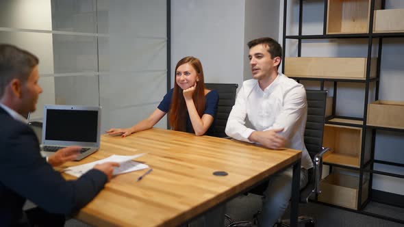 The Man and His Wife Speaking with Lawyer in Boardroom