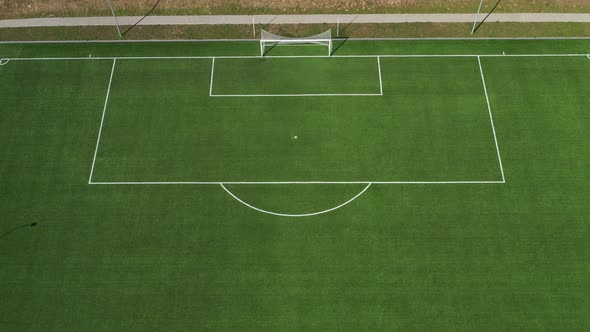 Top View of a Football Field with Green Grass Outdoors in Summer