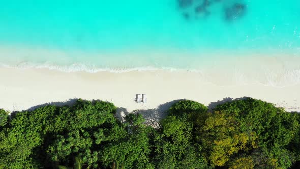 Aerial above travel of marine seashore beach holiday by transparent ocean with white sandy backgroun