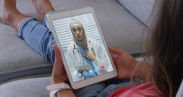 Woman talking on video meeting on her digital tablet