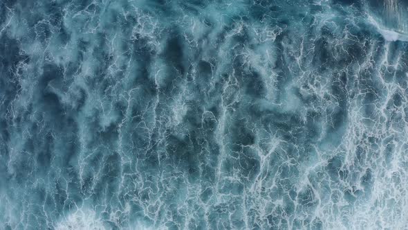 Slowmotion Top Down Aerial View of the Ocean Giant Waves Foaming and Splashing