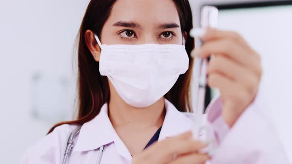 Female doctor talking to patient.doctor with syringe doing injection of vaccine