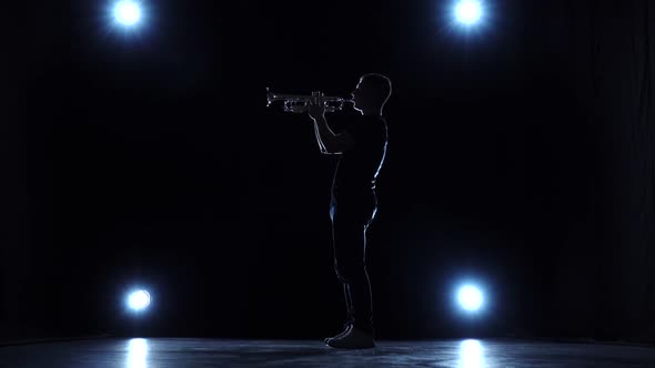 Musician in Studio with Spotlights Playing Trumpet Jazz. Slow Motion