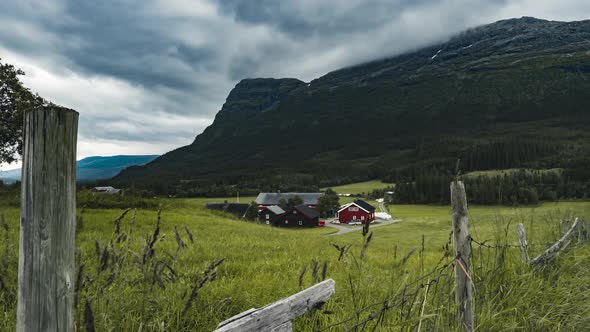 Beautiful Farmhouse On The Lush Field By The Mountain In Hemsedal, Norway - zoom-in shot - timelapse