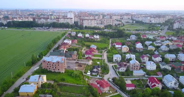 Village houses near the big city, shooting from a quadcopter